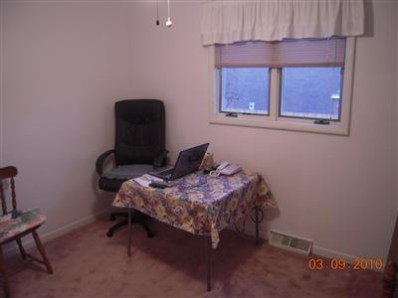823 Old Beach Road Dyer, IN 46311 - Photo 8 of 9 a bedroom with a bed and a chair
