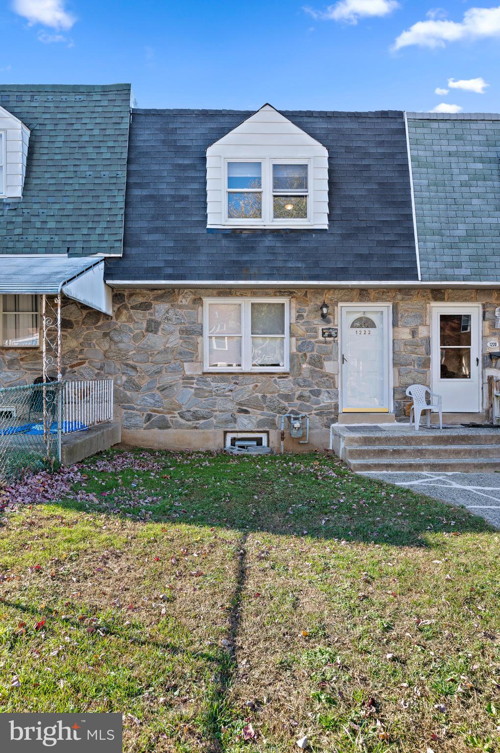 1222 Harshaw Road Brookhaven, PA 19015 - Photo 1 of 25 a view of a brick house with a yard