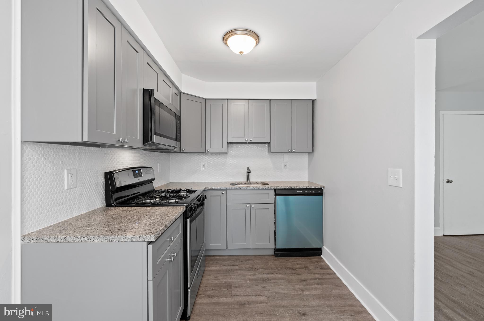 1222 Harshaw Road Brookhaven, PA 19015 - Photo 12 of 25 a kitchen with a sink and a stove top oven
