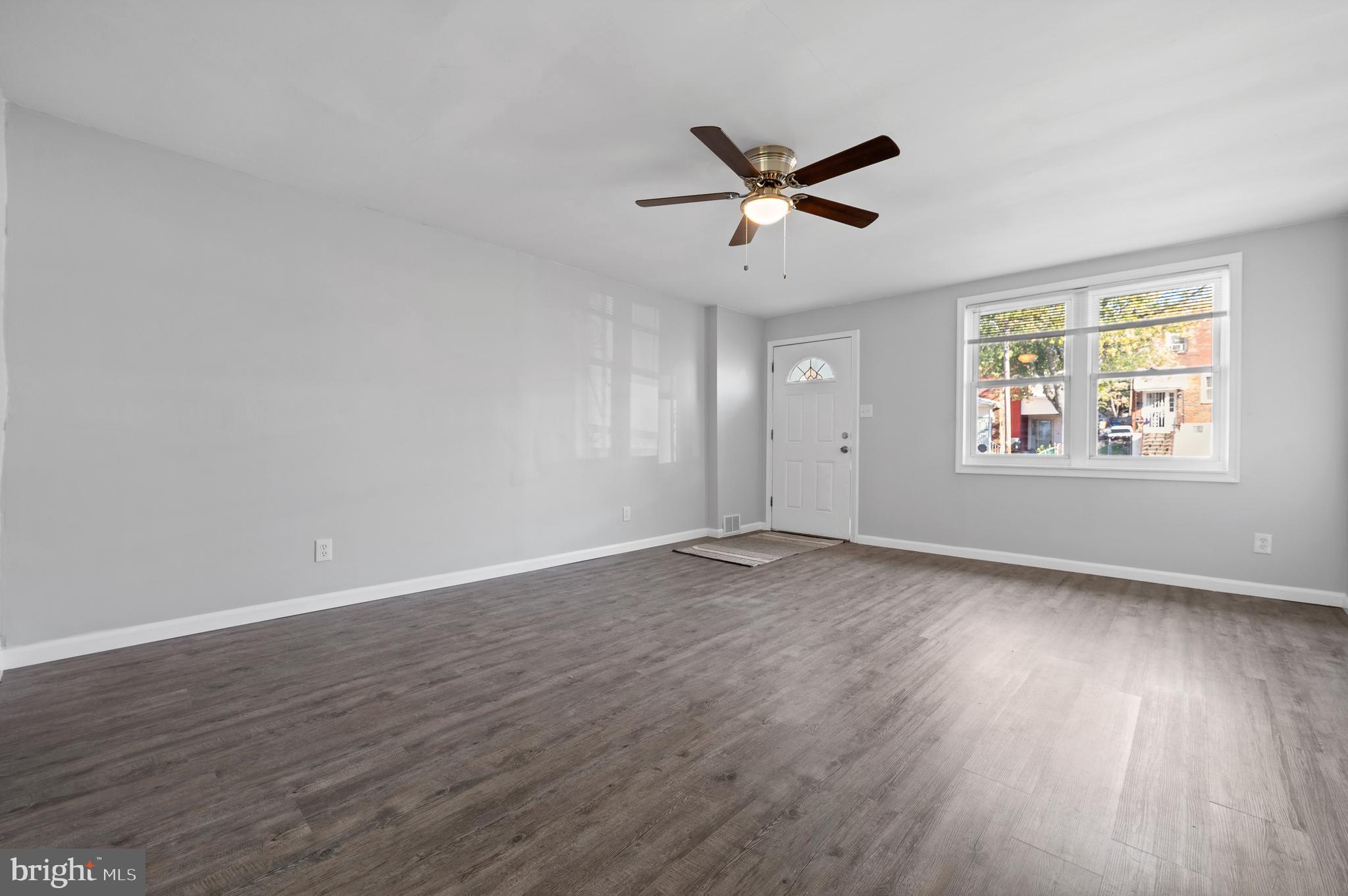 1222 Harshaw Road Brookhaven, PA 19015 - Photo 5 of 25 a view of an empty room with wooden floor and a window