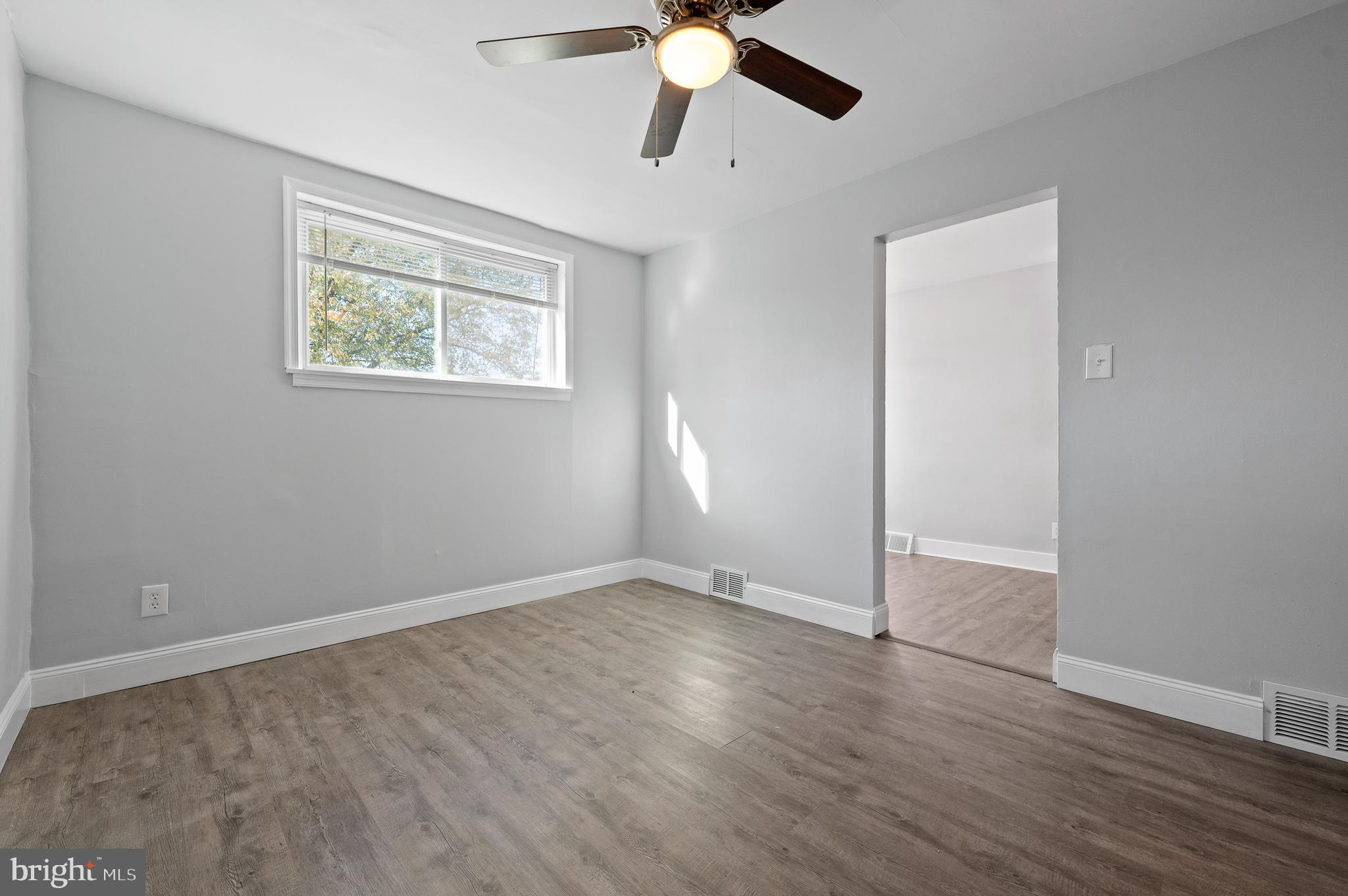1222 Harshaw Road Brookhaven, PA 19015 - Photo 8 of 25 a view of an empty room with wooden floor and a window