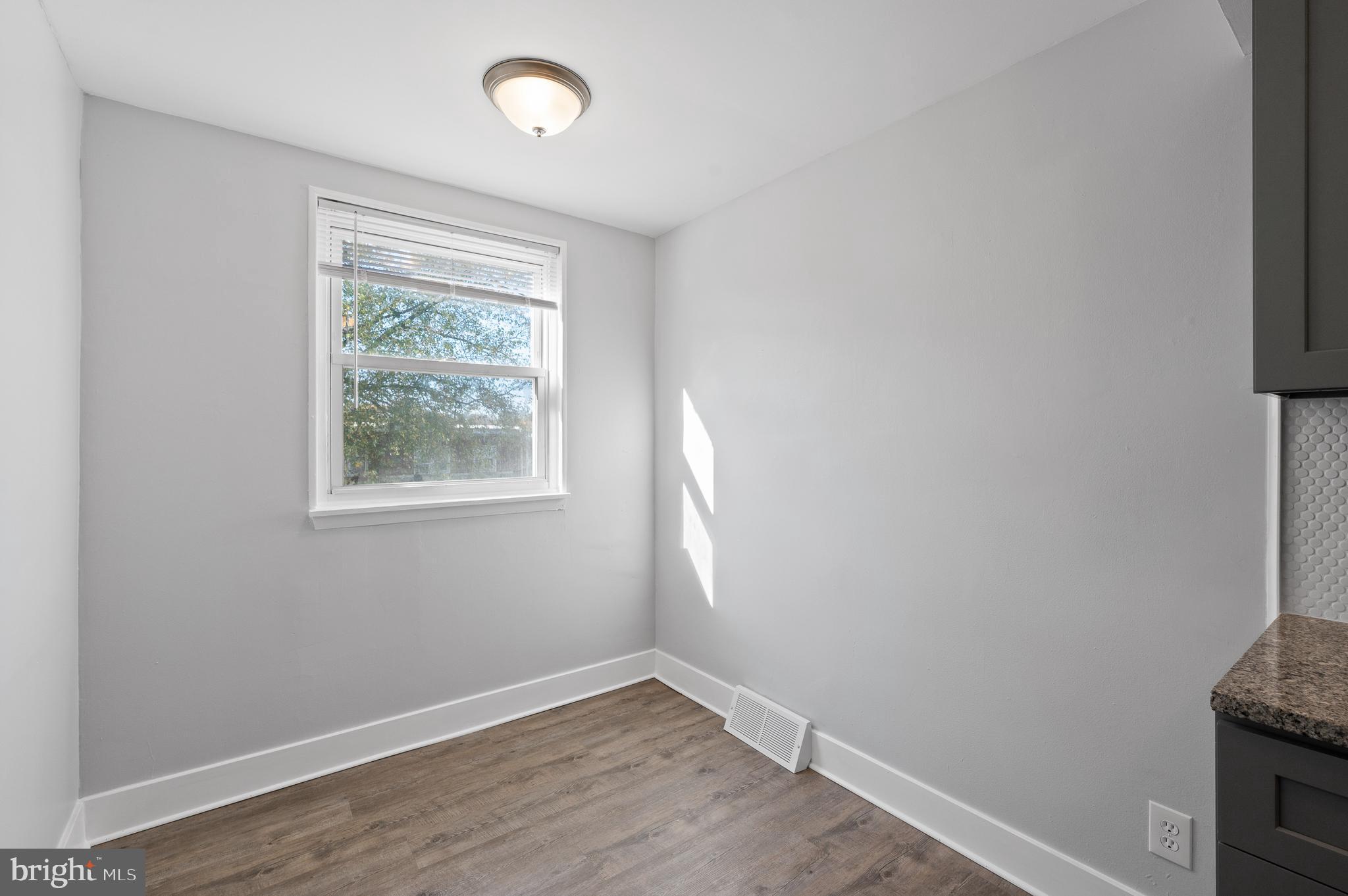 1222 Harshaw Road Brookhaven, PA 19015 - Photo 10 of 25 an empty room with wooden floor and windows