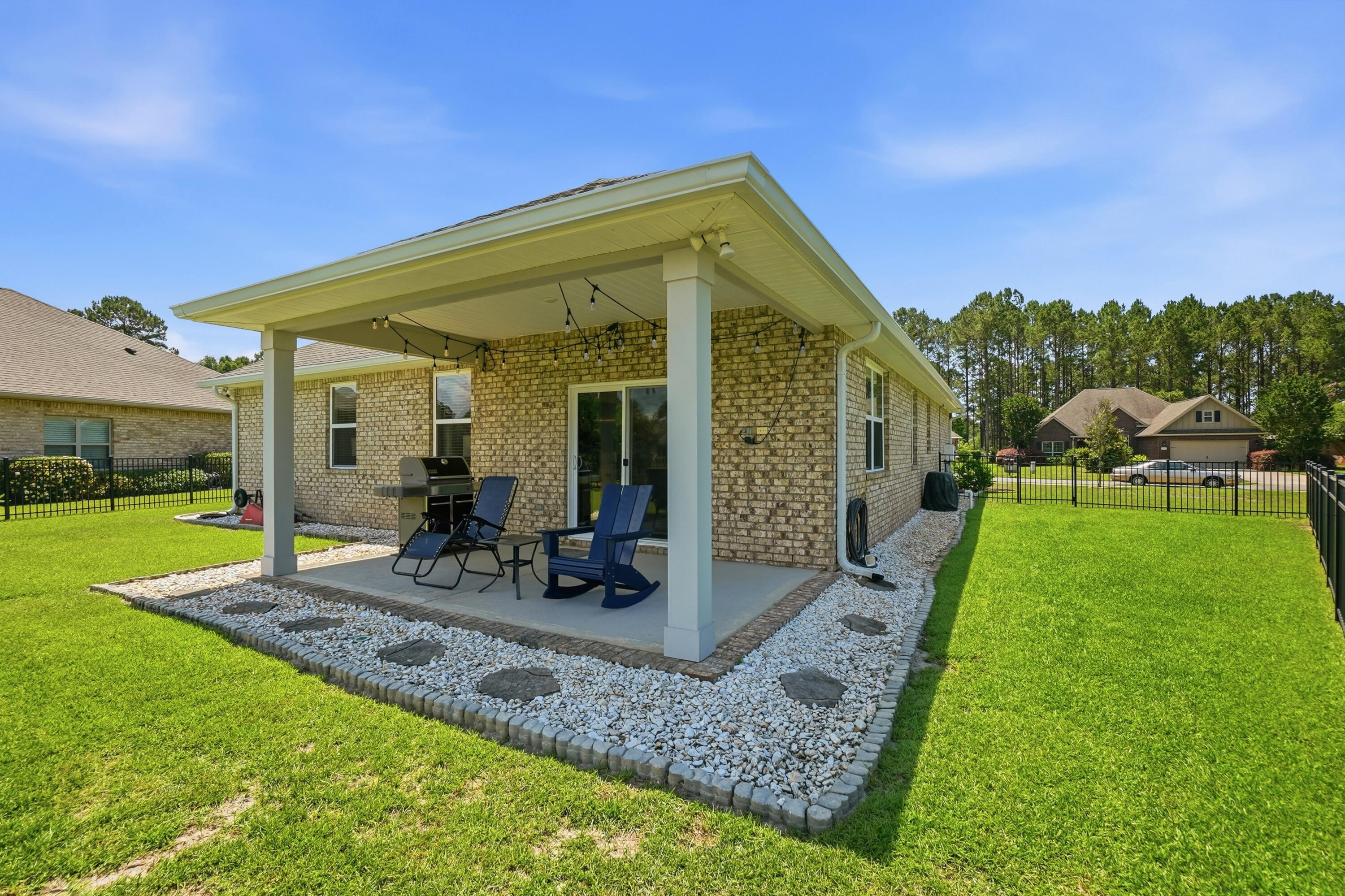 525 Windchime Way Freeport, FL 32439 - Photo 34 of 59 a view of a house with backyard porch and garden