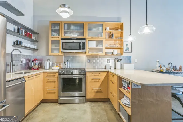 a kitchen that has a sink and a stove in it