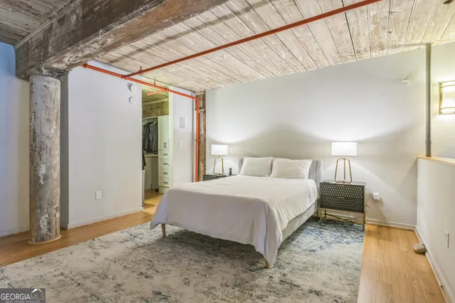 a bedroom with a bed and a night stand