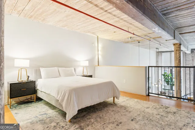 a bedroom with a bed and a mirror