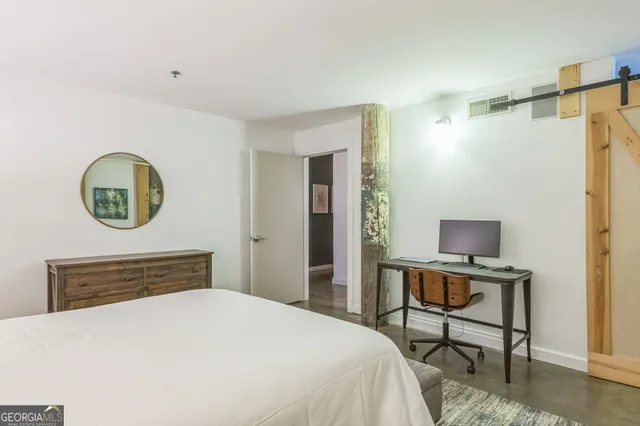 a bedroom with a bed and a table