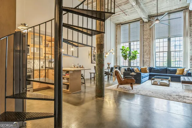 a dining room with furniture water view and a large window