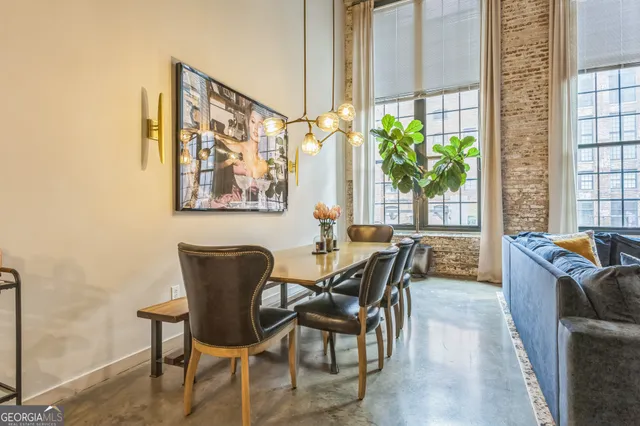 a dining room with furniture front door and wooden floor