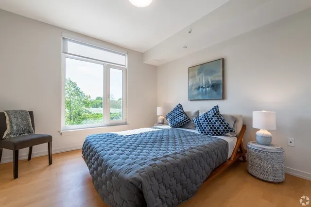 a bedroom with a bed and a window