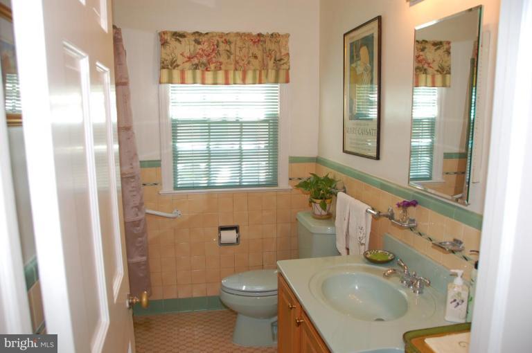 9507 Bruce Drive Silver Spring, MD 20901 - Photo 9 of 16 a bathroom with a sink toilet and shower