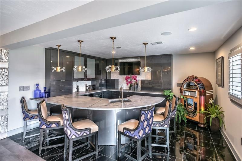 5 Little Meadow Road Wexford, PA 15090 - Photo 18 of 25 Wet Bar is Part of the Large Game Room in Lower Level. Has Refrigerator; ice maker; wine cooler; Marble Flooring; Has Large Gas Fireplace that is a show piece. Walk-out to private patio.