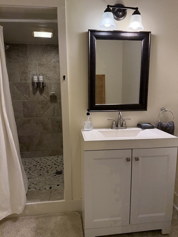 5 Bridge Street Montague, MA 01349 - Photo 11 of 36 a bathroom with a sink a mirror and shower