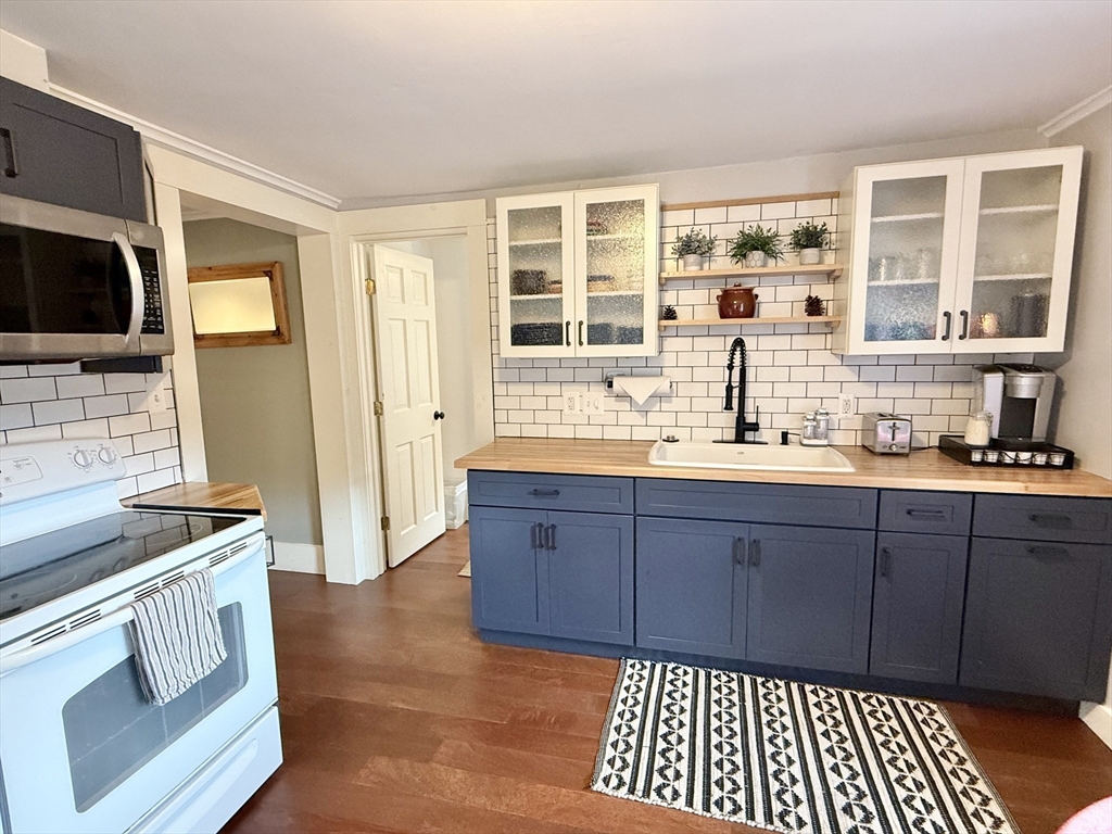 5 Bridge Street Montague, MA 01349 - Photo 17 of 36 a kitchen with stainless steel appliances granite countertop a stove a sink and a microwave