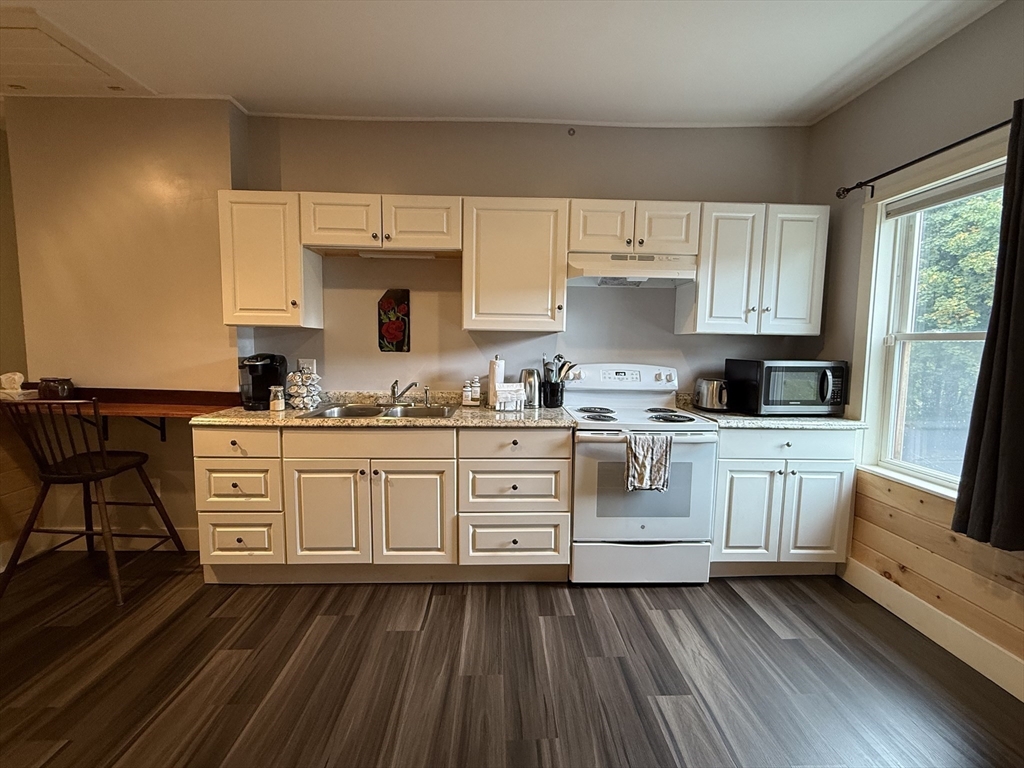 5 Bridge Street Montague, MA 01349 - Photo 4 of 36 a kitchen with white cabinets and appliances