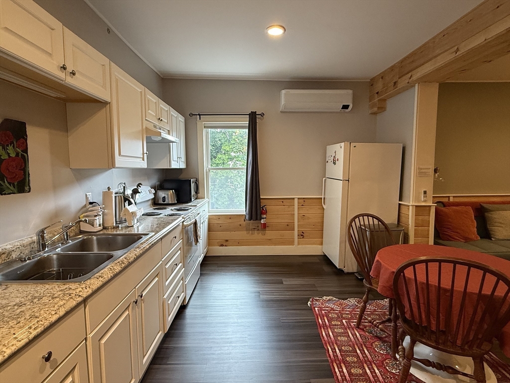 5 Bridge Street Montague, MA 01349 - Photo 6 of 36 a kitchen with sink a refrigerator and chairs