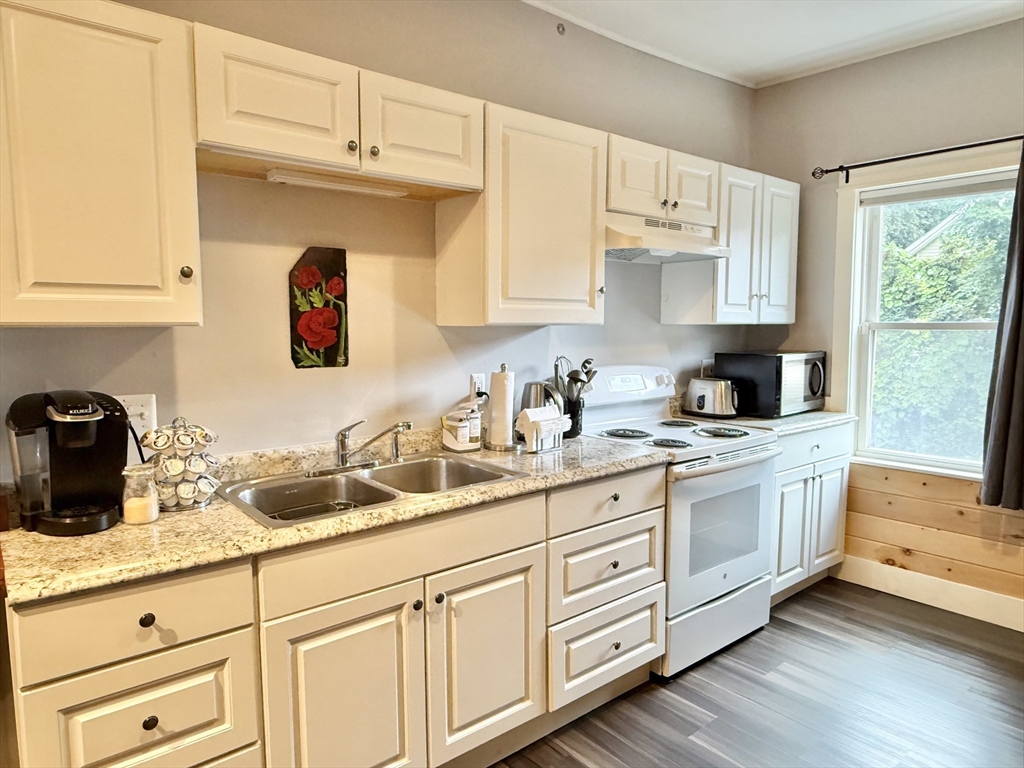 5 Bridge Street Montague, MA 01349 - Photo 7 of 36 a kitchen with granite countertop white cabinets and white appliances