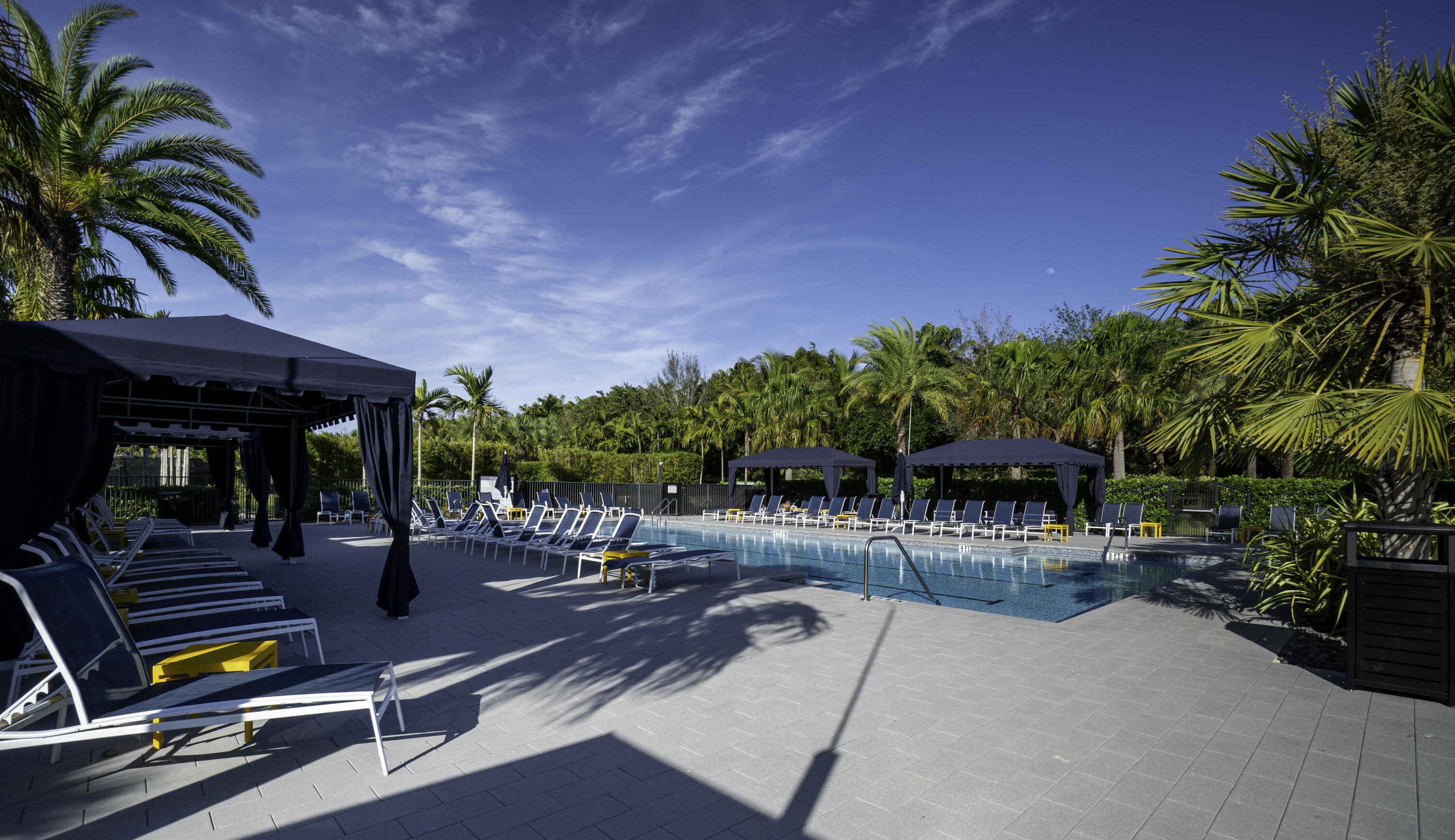 17081 Five Waters Avenue Boca Raton, FL 33496 - Photo 106 of 109 a view of a swimming pool with lawn chairs and plants