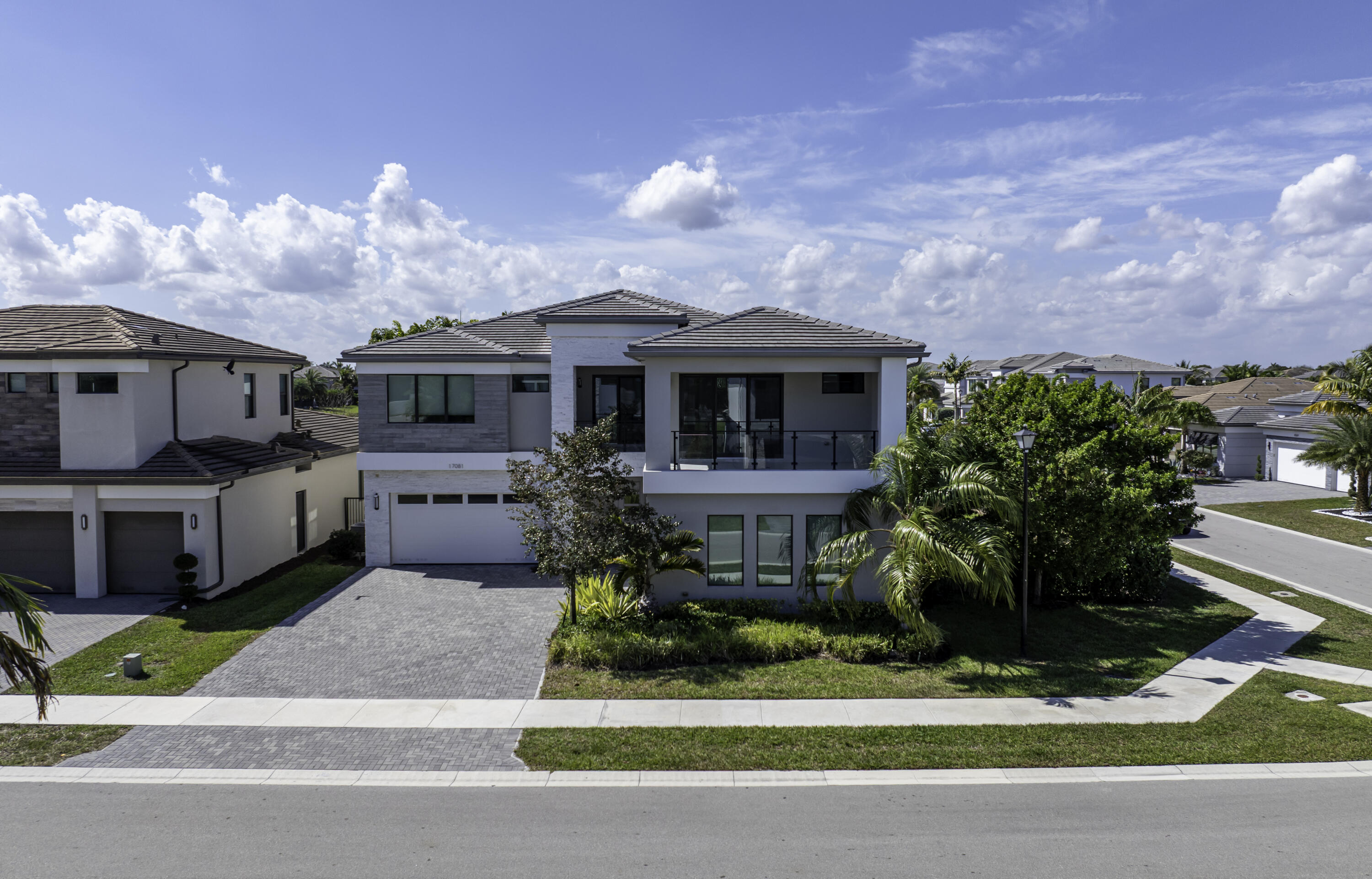 17081 Five Waters Avenue Boca Raton, FL 33496 - Photo 2 of 109 a front view of a house with garden