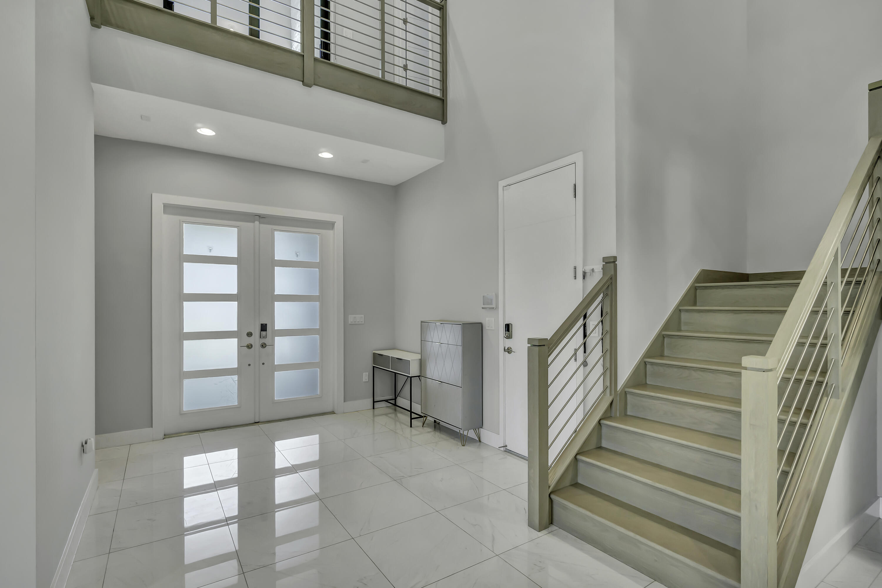 17081 Five Waters Avenue Boca Raton, FL 33496 - Photo 22 of 109 a view of entryway with stairs and wooden floor