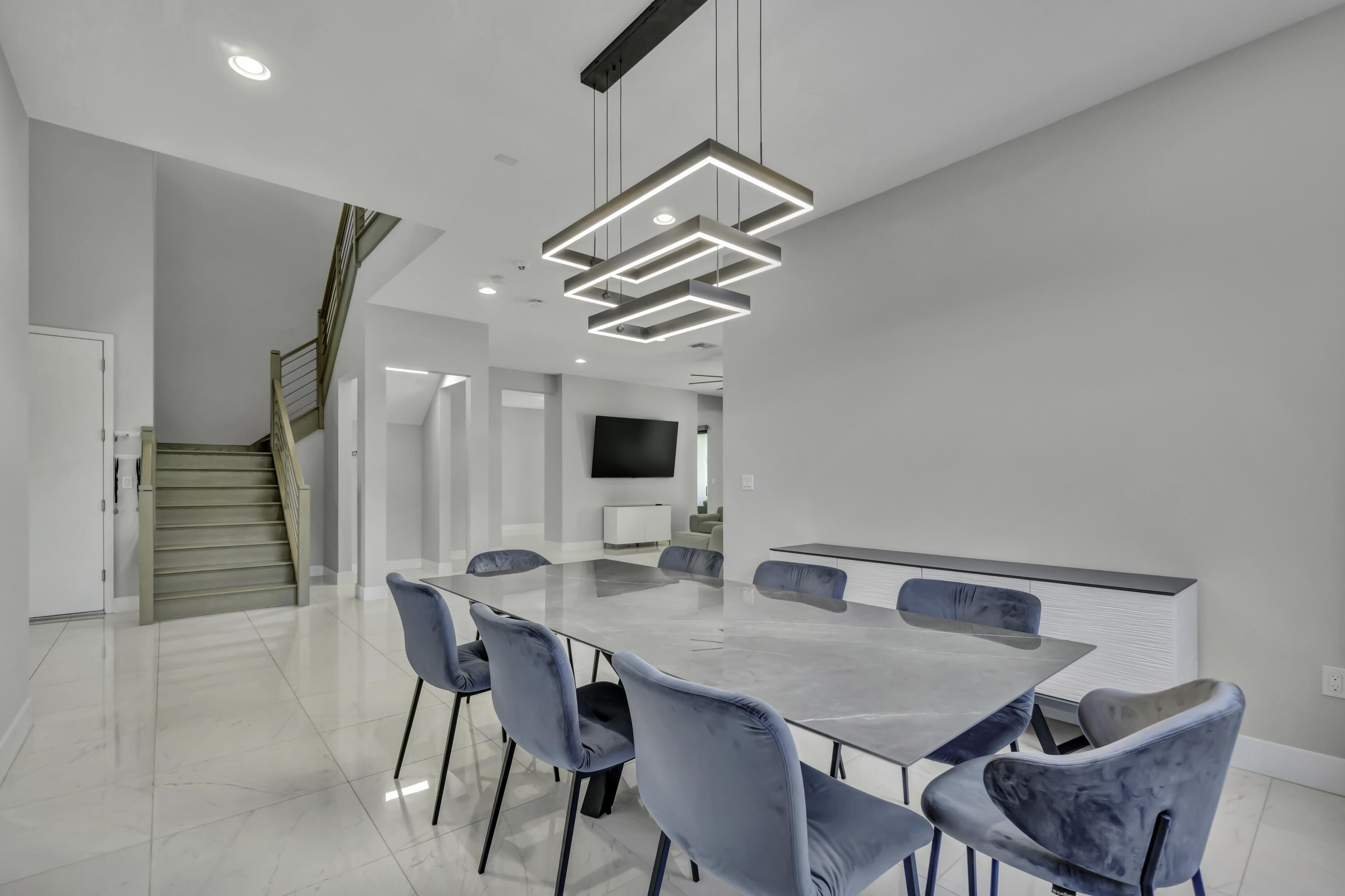 17081 Five Waters Avenue Boca Raton, FL 33496 - Photo 24 of 109 a view of a dining room with furniture and a chandelier fan