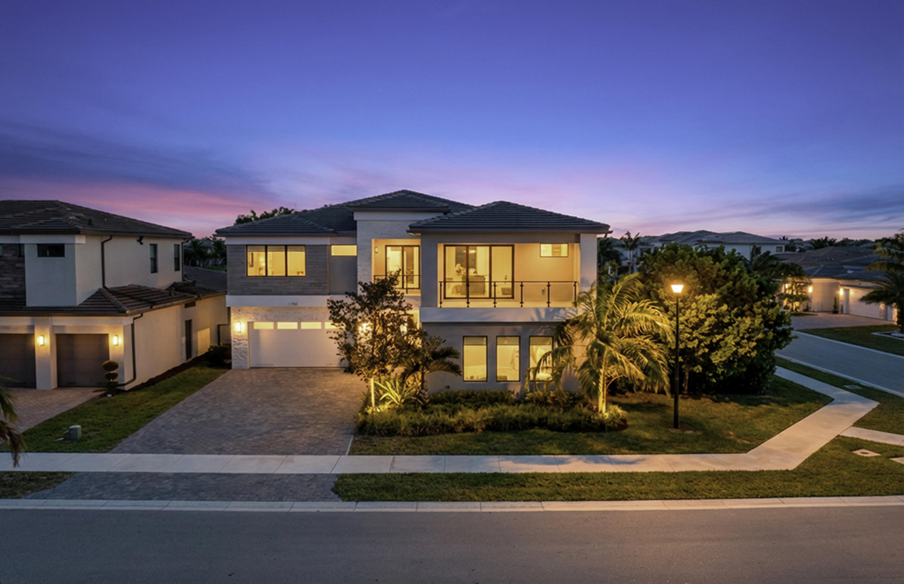 17081 Five Waters Avenue Boca Raton, FL 33496 - Photo 3 of 109 a front view of a house with a yard