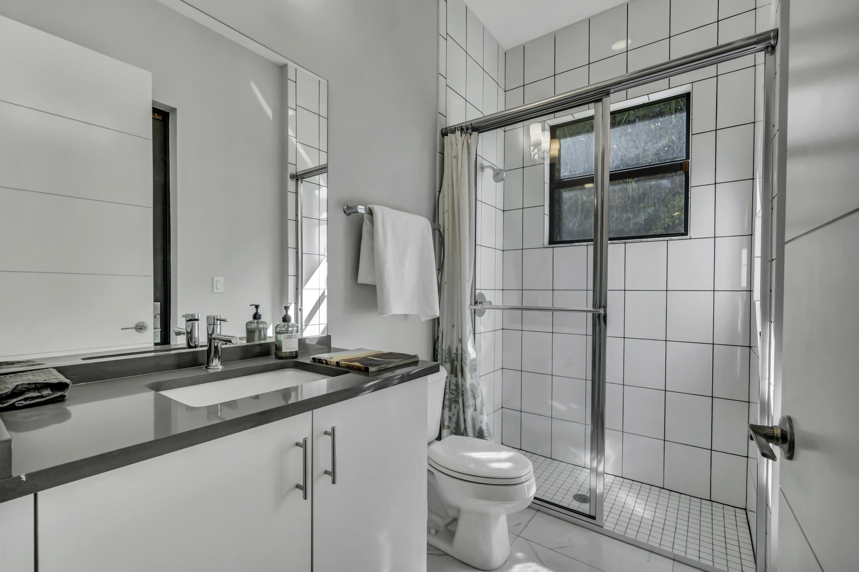 17081 Five Waters Avenue Boca Raton, FL 33496 - Photo 39 of 109 a bathroom with a sink and a mirror