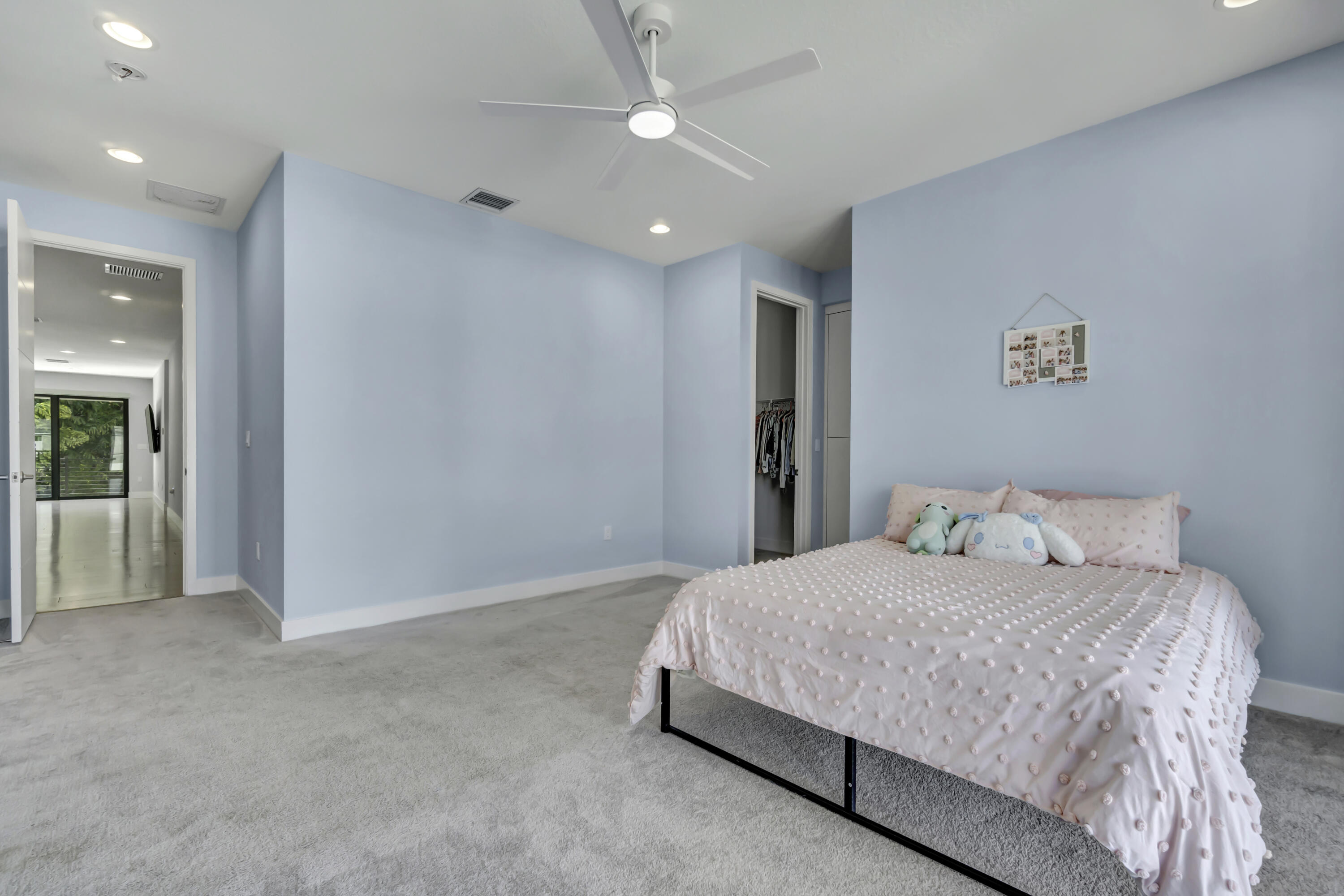 17081 Five Waters Avenue Boca Raton, FL 33496 - Photo 61 of 109 a bedroom with a bed and a lamp