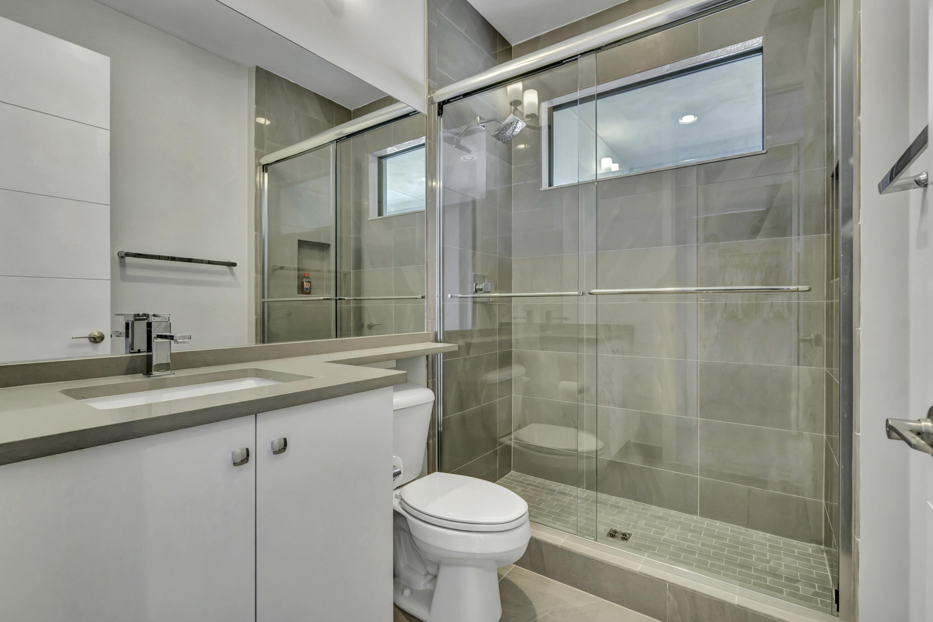 17081 Five Waters Avenue Boca Raton, FL 33496 - Photo 63 of 109 a bathroom with a sink toilet and shower