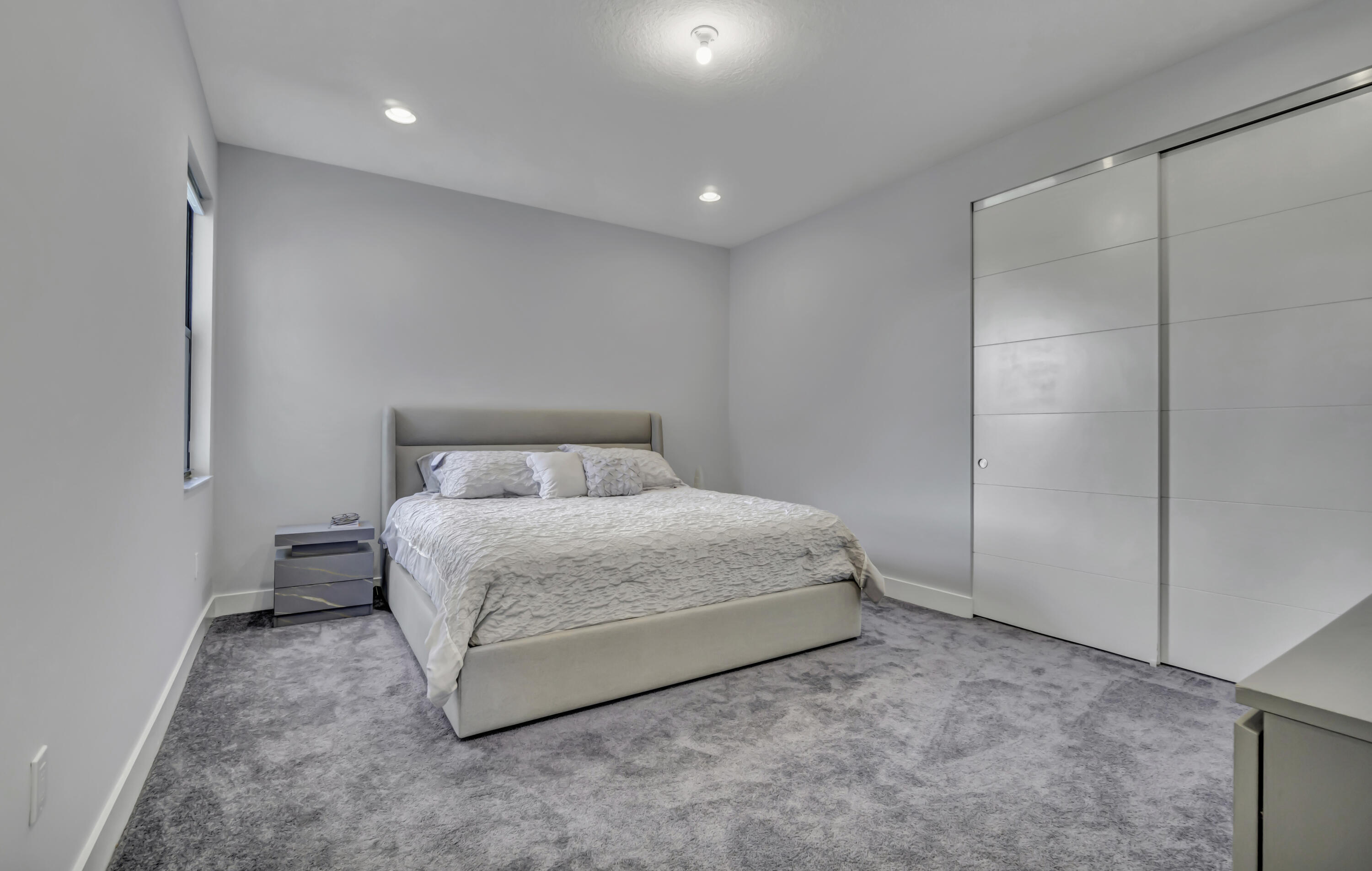 17081 Five Waters Avenue Boca Raton, FL 33496 - Photo 69 of 109 a bed room with a bed and a night stand