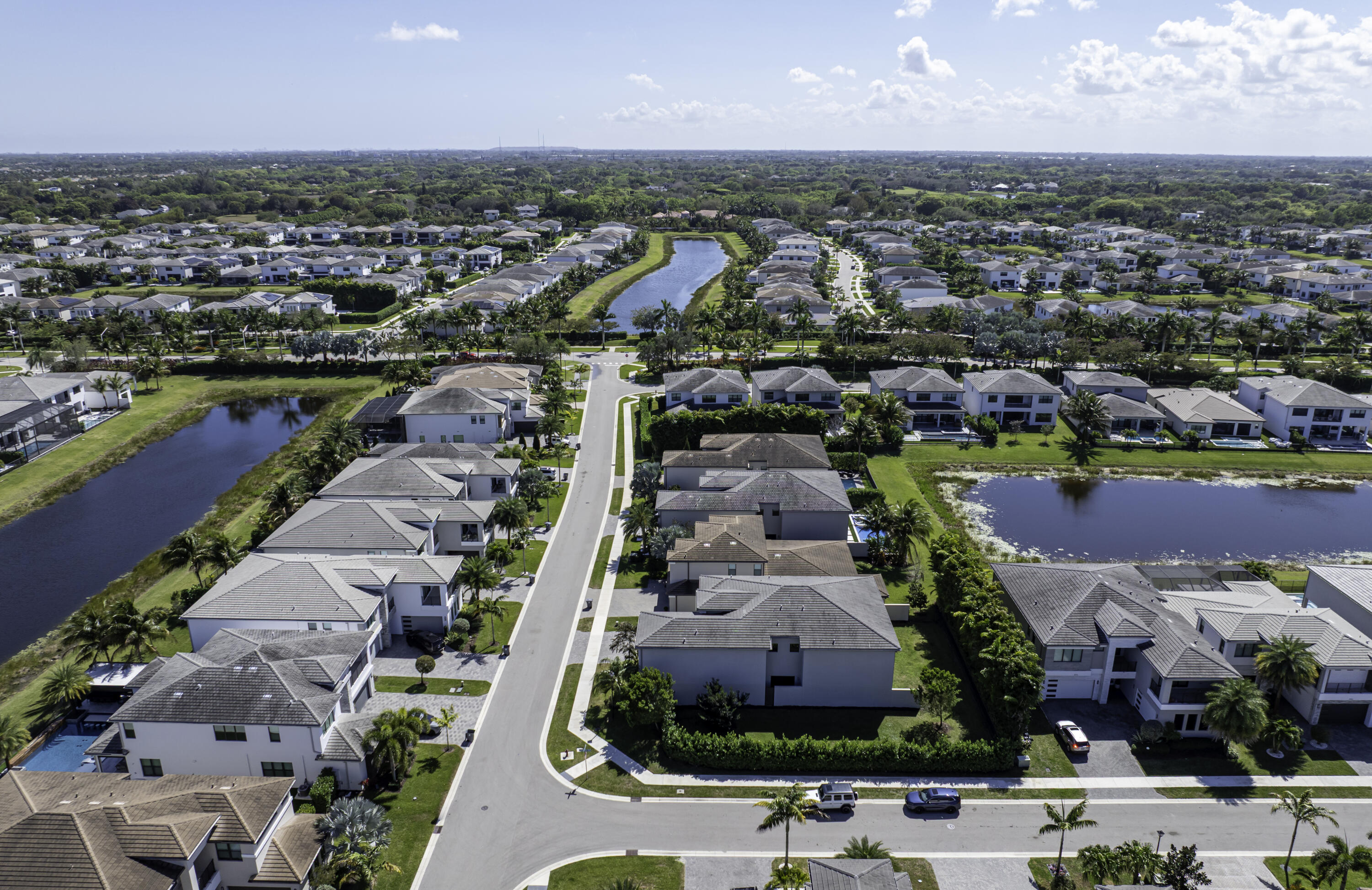 17081 Five Waters Avenue Boca Raton, FL 33496 - Photo 9 of 109 an aerial view of a city with lots of residential buildings ocean and mountain view in back