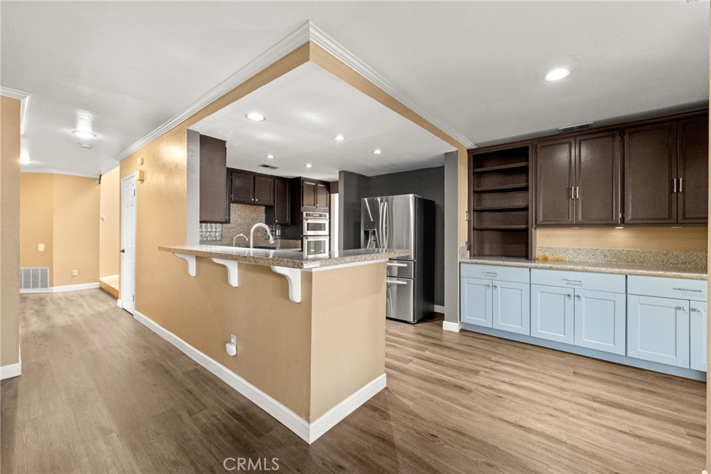 40219 Donomore Court Temecula, CA 92591 - Photo 13 of 63 a kitchen with stainless steel appliances granite countertop a refrigerator and a stove top oven