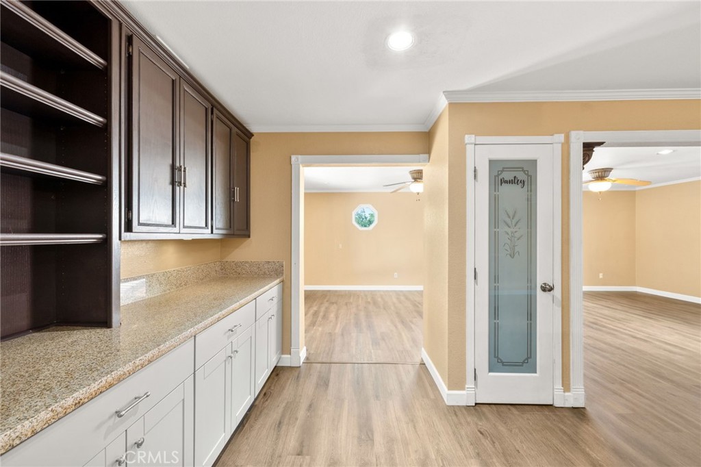 40219 Donomore Court Temecula, CA 92591 - Photo 16 of 63 a view of hallway with wooden floor and cabinets