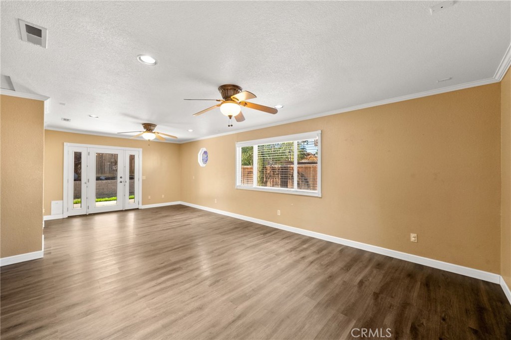 40219 Donomore Court Temecula, CA 92591 - Photo 21 of 63 an empty room with wooden floor and windows