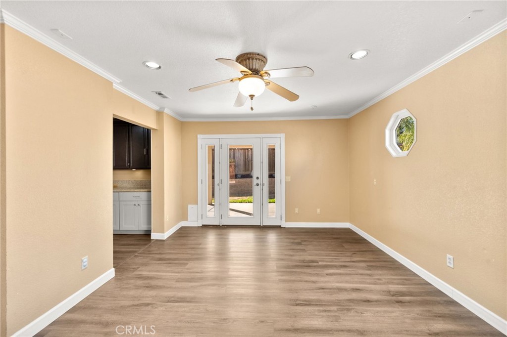 40219 Donomore Court Temecula, CA 92591 - Photo 22 of 63 a view of an empty room with window and wooden floor