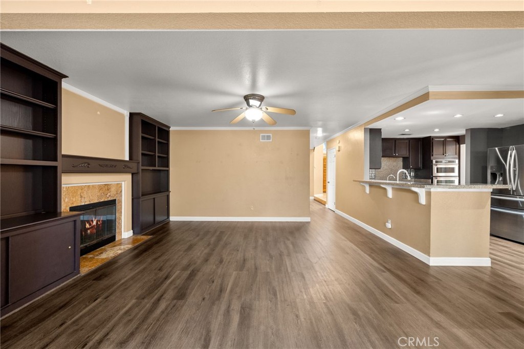40219 Donomore Court Temecula, CA 92591 - Photo 24 of 63 wooden floor in an empty room with a fireplace and a window