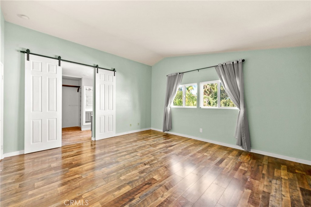 40219 Donomore Court Temecula, CA 92591 - Photo 32 of 63 a view of an empty room with wooden floor and a window