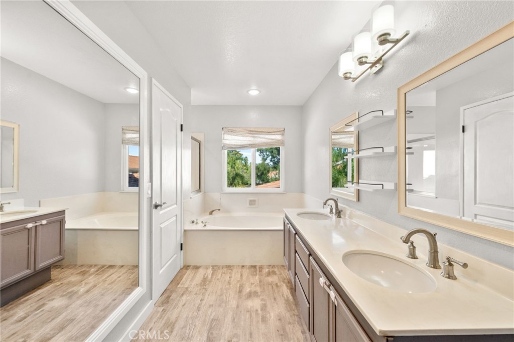 40219 Donomore Court Temecula, CA 92591 - Photo 34 of 63 a bathroom with a tub sink shower and two mirror