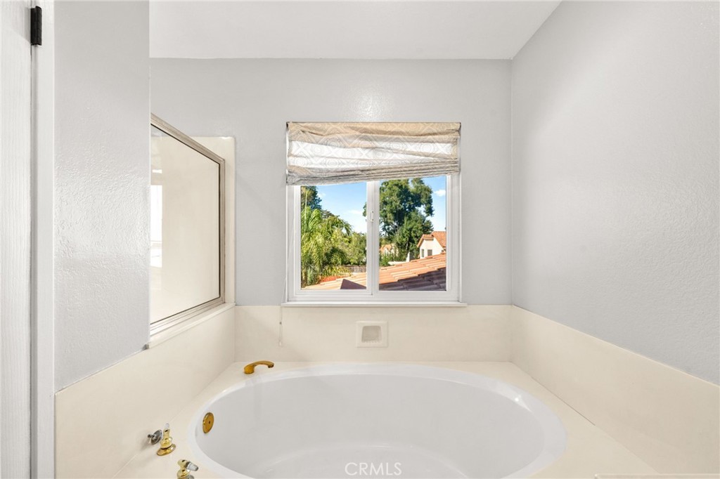 40219 Donomore Court Temecula, CA 92591 - Photo 36 of 63 a white bath tub sitting in a bathroom next to a window