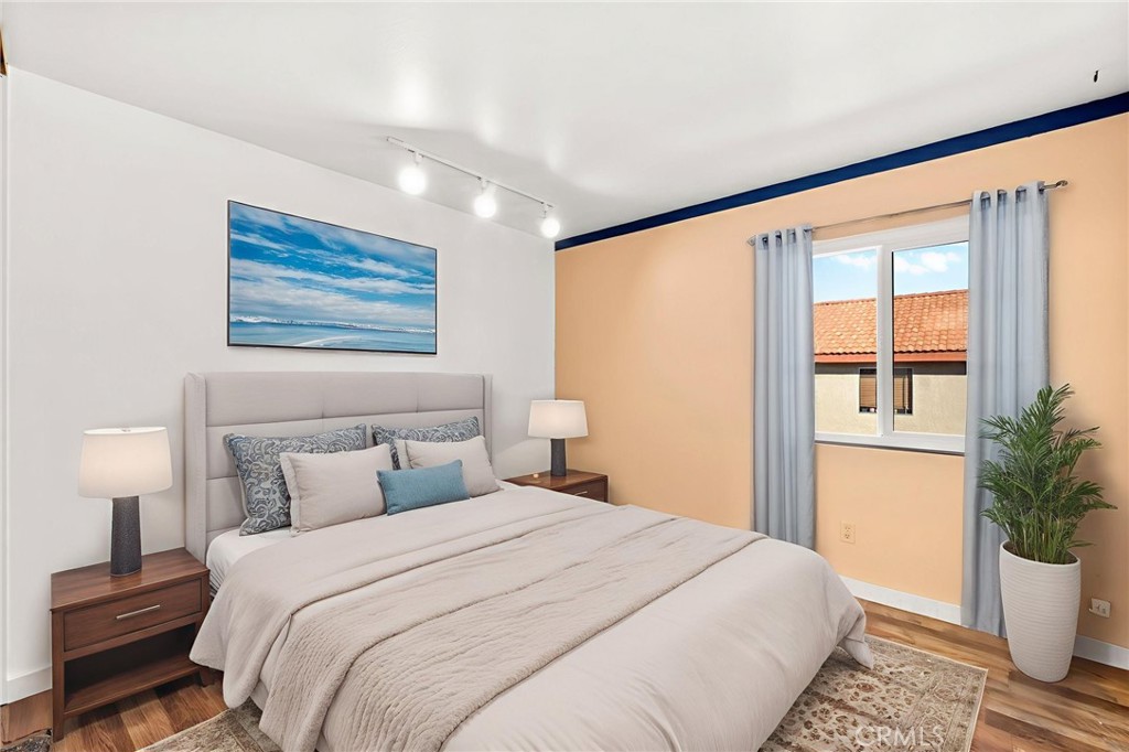 40219 Donomore Court Temecula, CA 92591 - Photo 40 of 63 a bedroom with a large bed and a potted plant