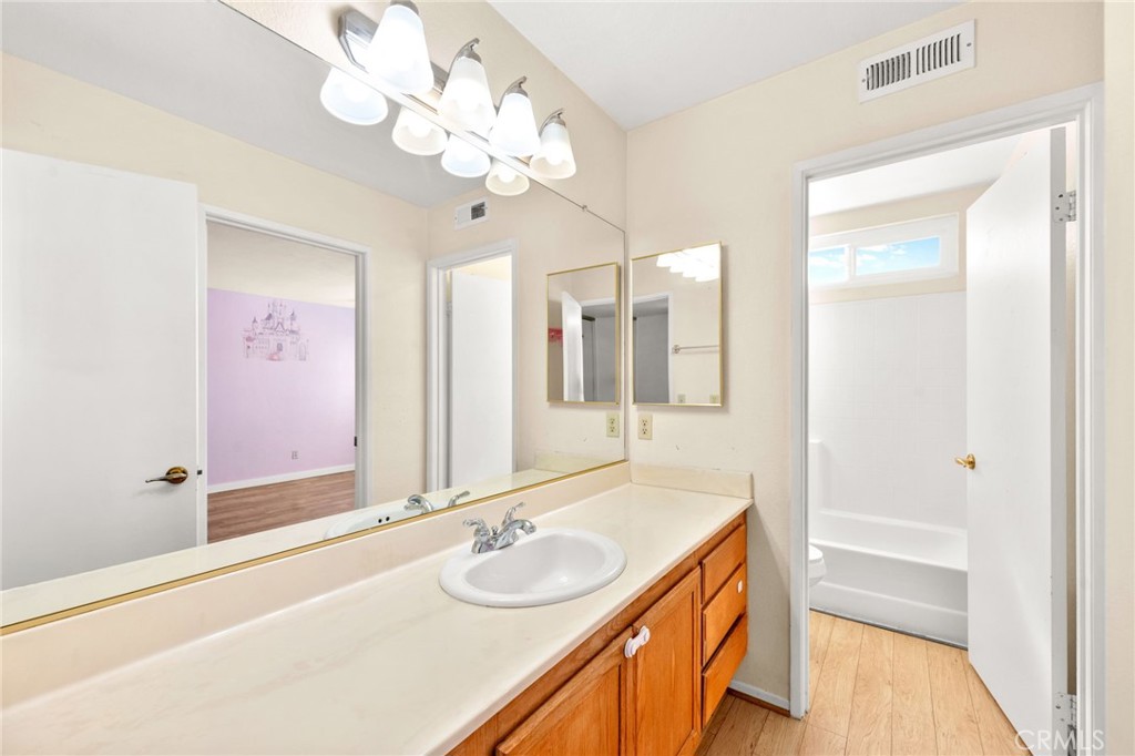 40219 Donomore Court Temecula, CA 92591 - Photo 42 of 63 a bathroom with a sink a vanity a mirror and a shower