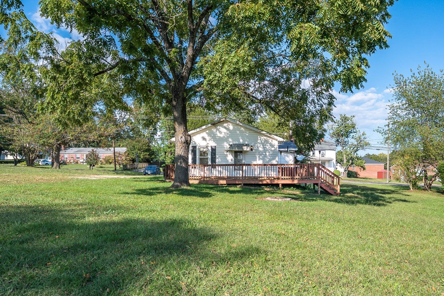 10435 Red House Road Appomattox, VA 24522 - Photo 5 of 32 a view of a house with a big yard and large trees