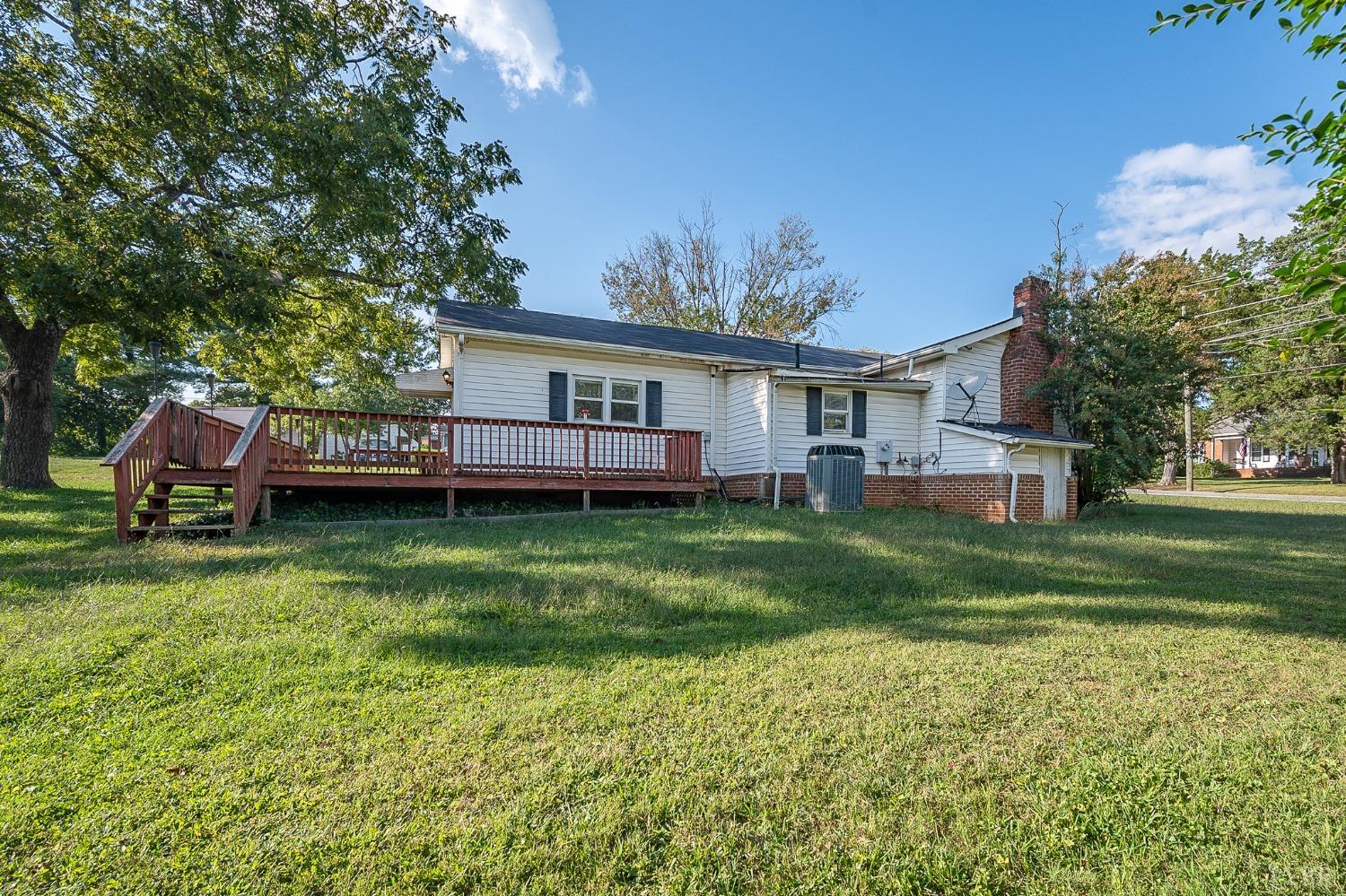 10435 Red House Road Appomattox, VA 24522 - Photo 7 of 32 a front view of a house with a garden and trees