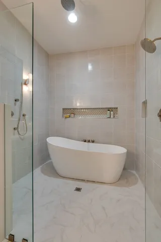 a white bath tub sitting in a bathroom