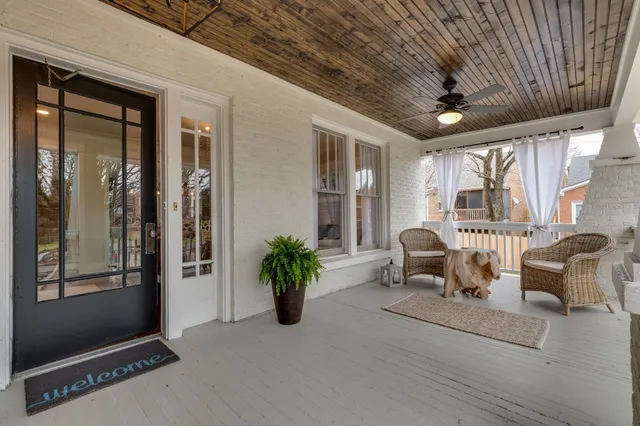 a lobby with furniture and potted plants