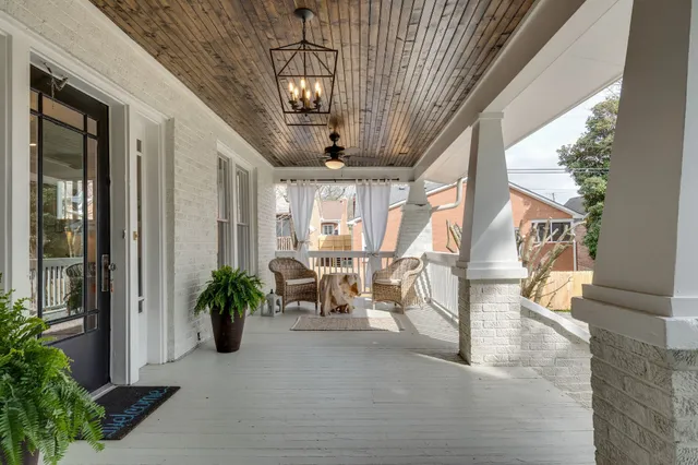 a open kitchen with white cabinets and wooden floor