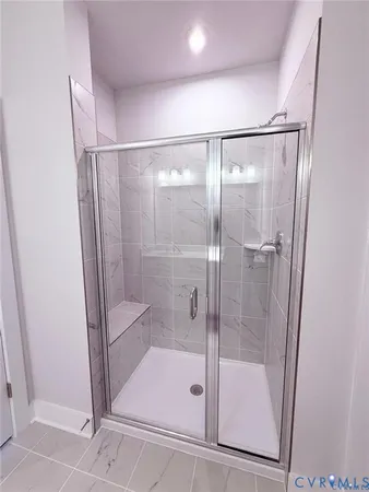 a bathroom with a glass shower door