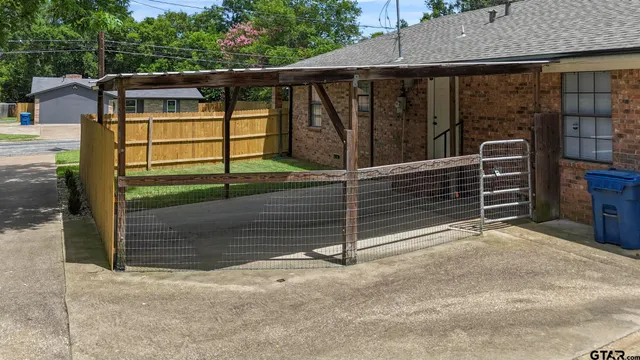 a view of a house with a wooden fence