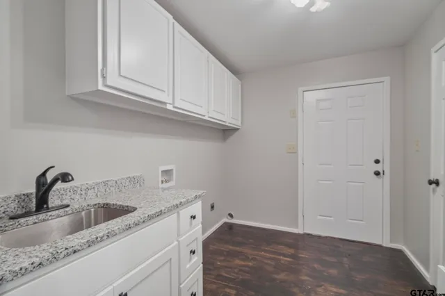 a view of a kitchen sink and cabinets