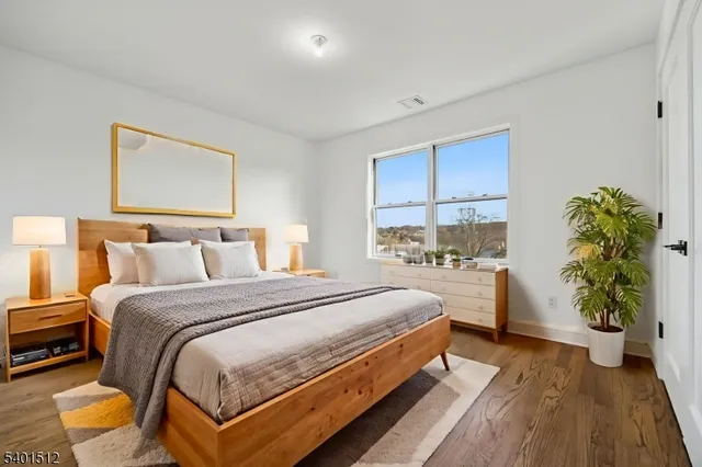 a bedroom with bed and a potted plant